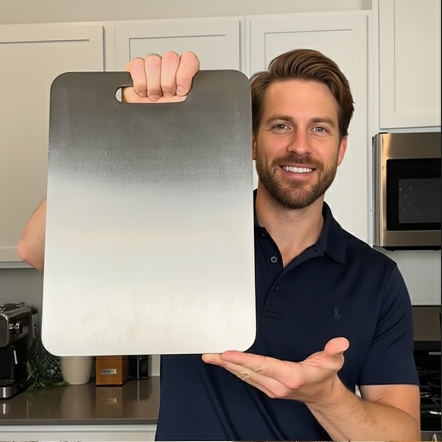 Man holding a Titan Haus titanium cutting board in his kitchen